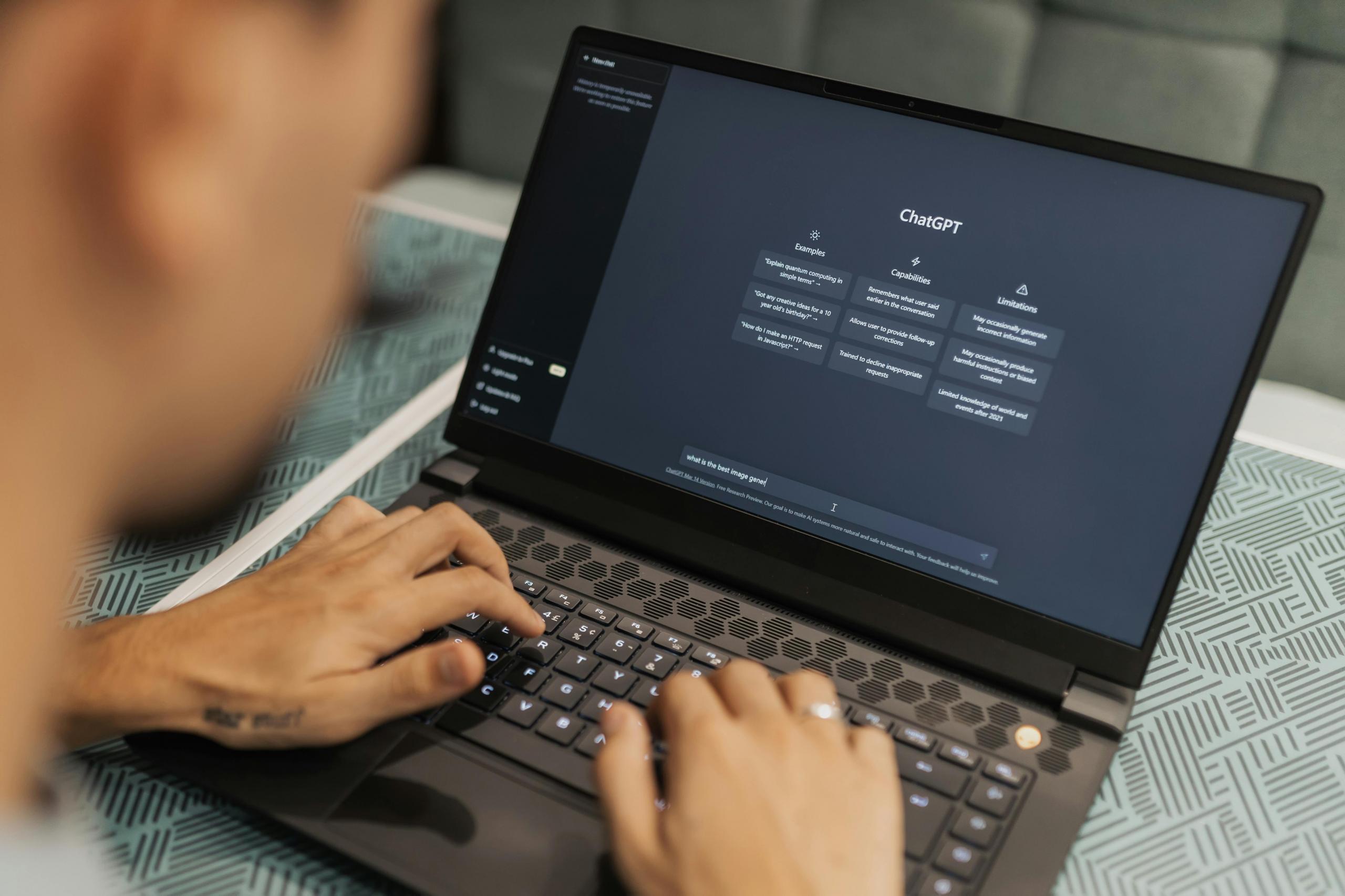 Person typing on the computer with Chat GPT on the screen.
