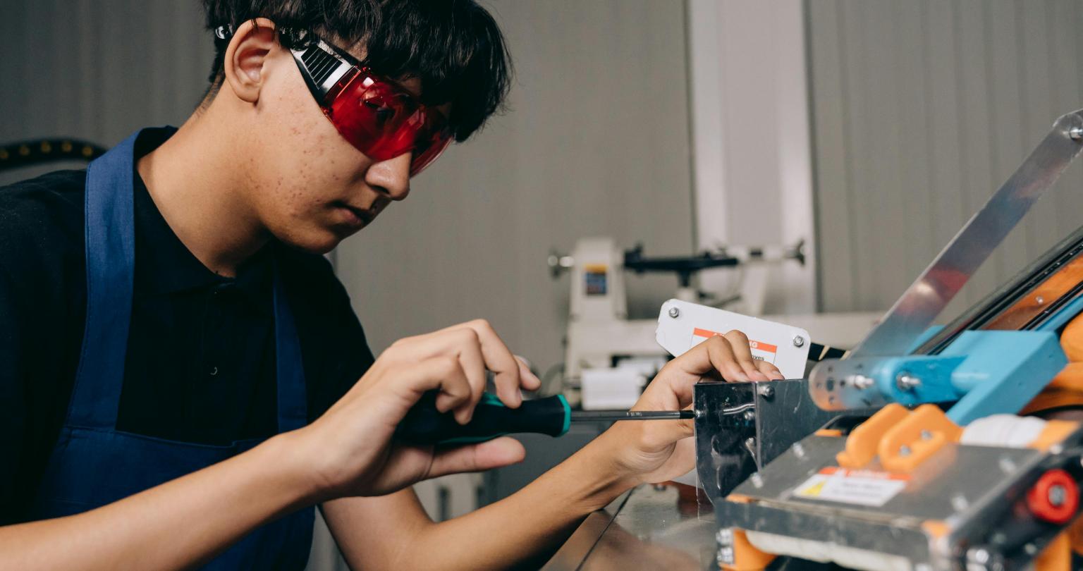 Young Gen Z man building some technology.