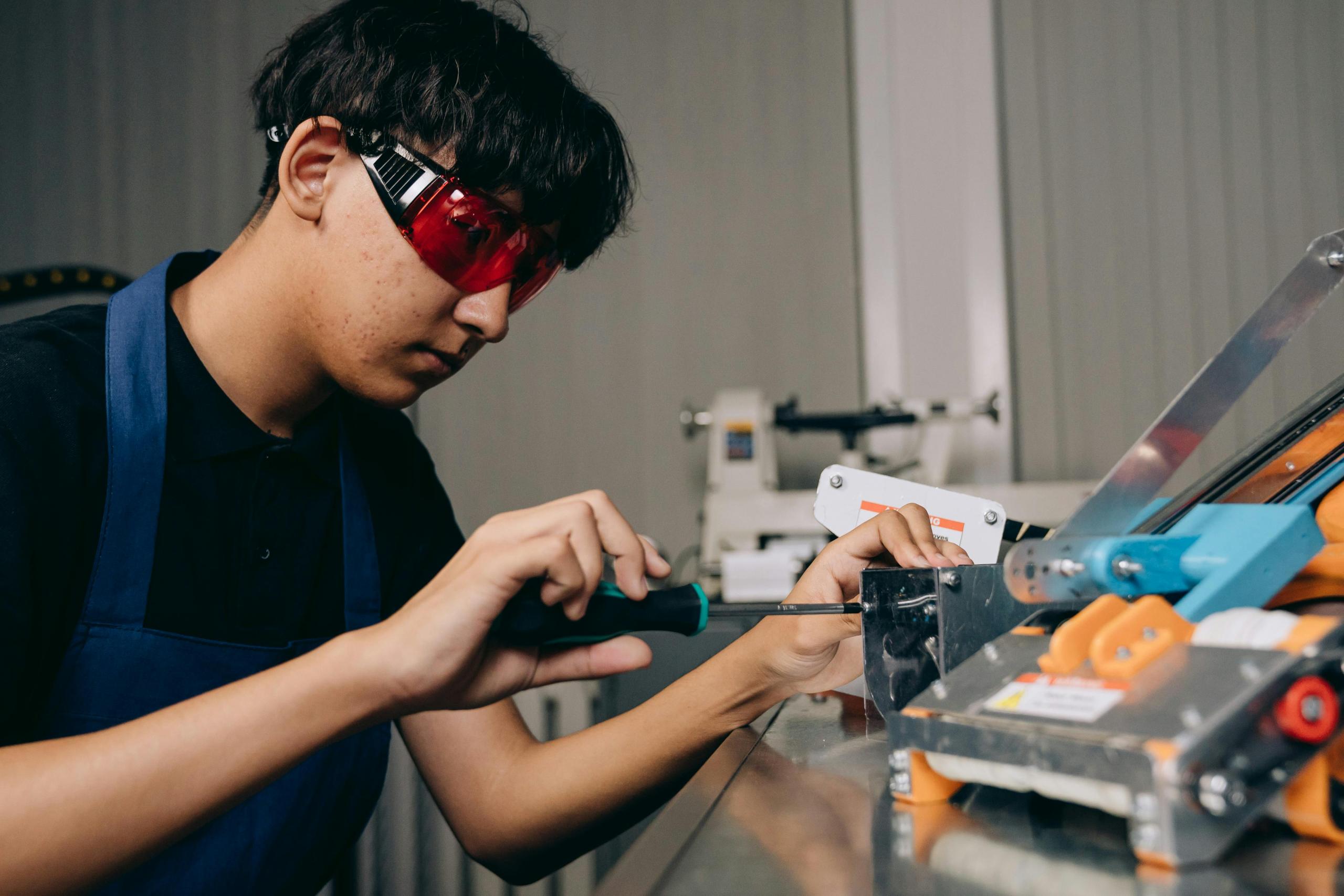 Young Gen Z man building some technology.