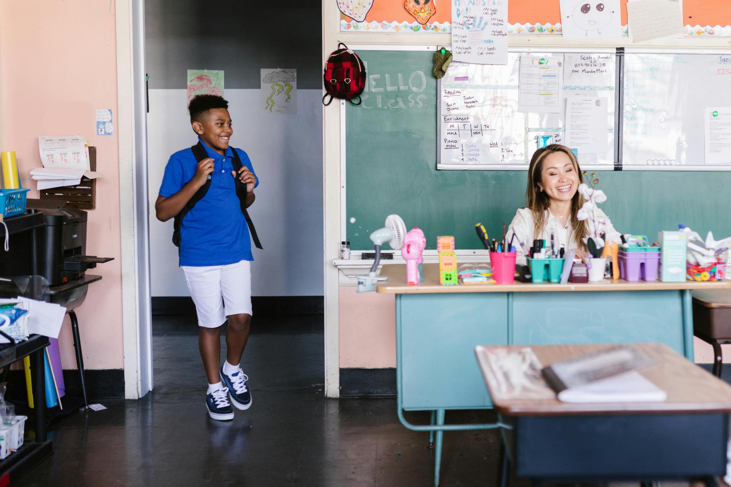 Happy student walking into a classroom